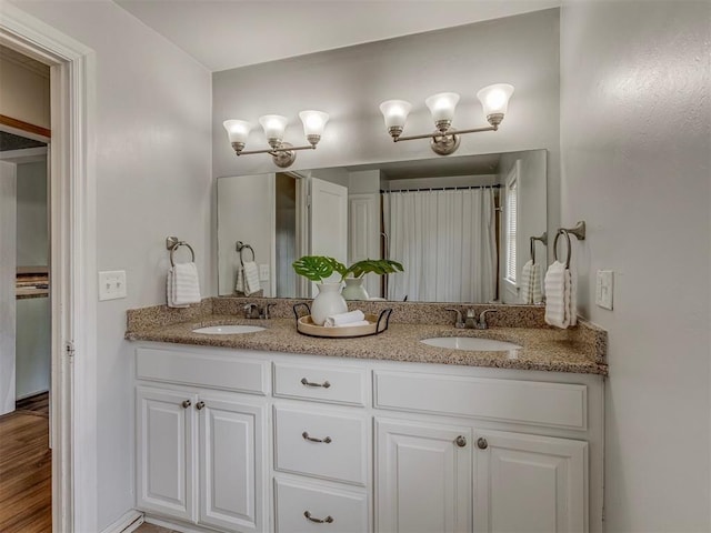 901 S 11th St, Kingfisher, OK 73750 - full bath featuring double vanity and wood finished floors