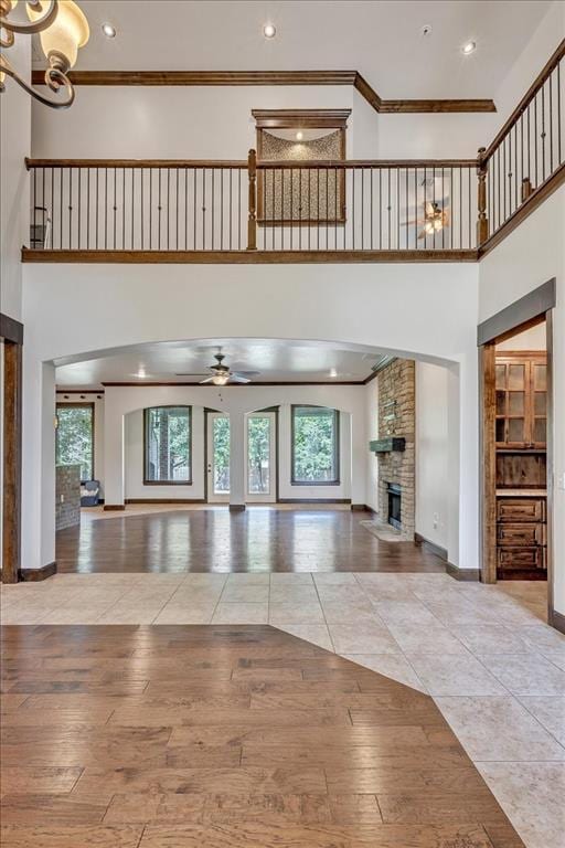 5000 Tower Bridge Court, Edmond, OK 73034 - entryway featuring a high ceiling, plenty of natural light, a large fireplace, a chandelier, and a ceiling fan