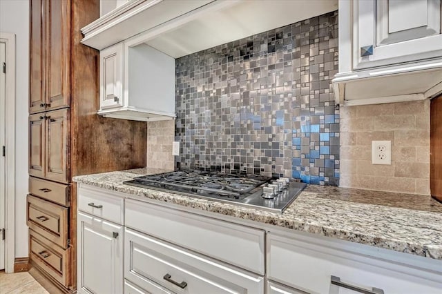 5000 Tower Bridge Court, Edmond, OK 73034 - kitchen featuring stainless steel gas cooktop, tasteful backsplash, and light stone counters