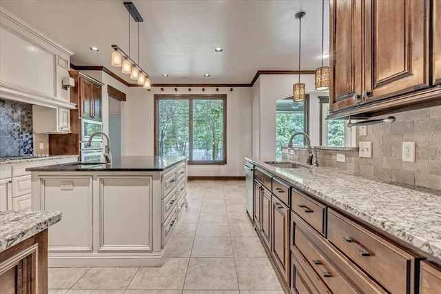 5000 Tower Bridge Court, Edmond, OK 73034 - kitchen with light stone countertops, ornamental molding, backsplash, light tile patterned floors, and dishwasher