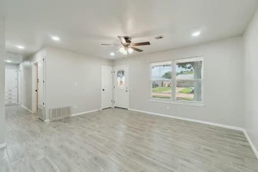107 Cimarron Ter, Cashion, OK 73016 - unfurnished living room with recessed lighting, ceiling fan, and wood finished floors