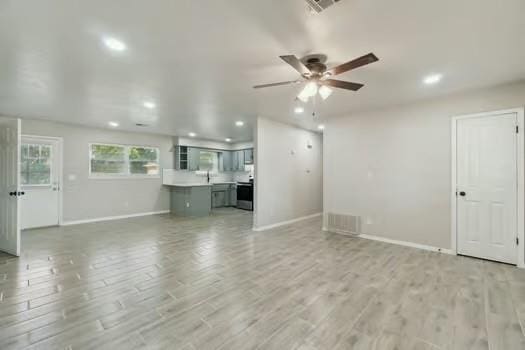 107 Cimarron Ter, Cashion, OK 73016 - unfurnished living room with recessed lighting, ceiling fan, and light wood-type flooring