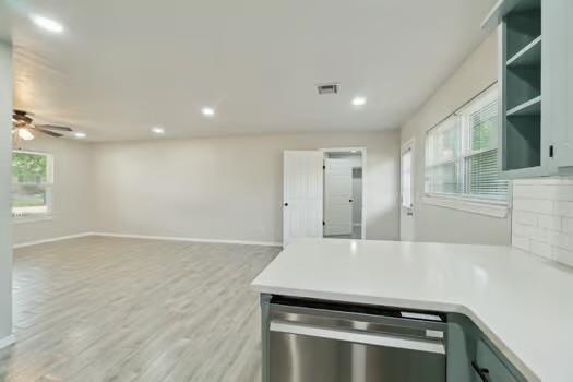 107 Cimarron Ter, Cashion, OK 73016 - kitchen featuring stainless steel dishwasher, open floor plan, a ceiling fan, a peninsula, and recessed lighting