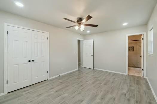 107 Cimarron Ter, Cashion, OK 73016 - unfurnished bedroom featuring recessed lighting, light wood-type flooring, a closet, connected bathroom, and a ceiling fan