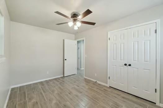 107 Cimarron Ter, Cashion, OK 73016 - unfurnished bedroom with light wood-style flooring, a closet, and a ceiling fan