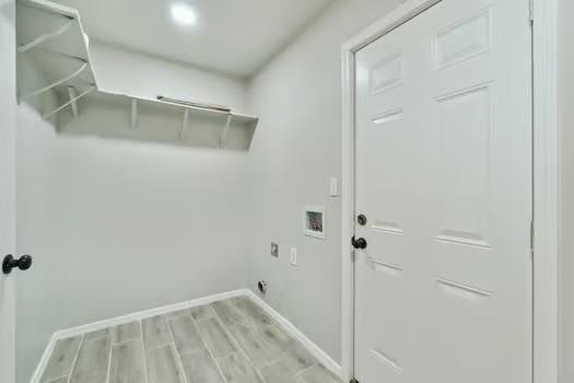 107 Cimarron Ter, Cashion, OK 73016 - laundry room featuring washer hookup, wood finished floors, and electric dryer hookup