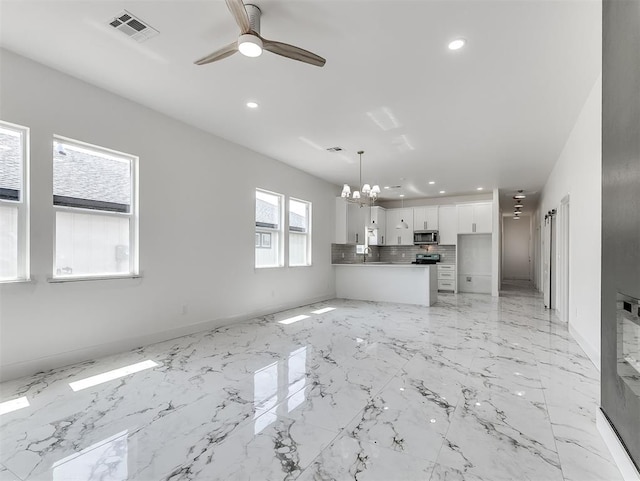 532 NW 112th St, Oklahoma City, OK 73114 - unfurnished living room with recessed lighting, ceiling fan, and a chandelier
