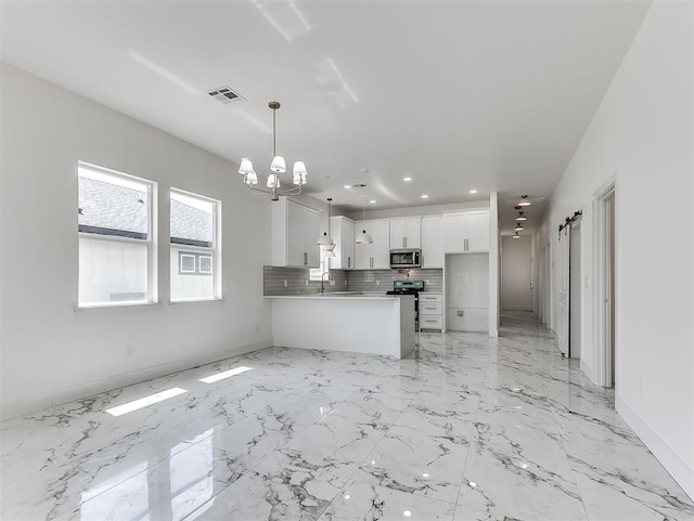 532 NW 112th St, Oklahoma City, OK 73114 - kitchen featuring stainless steel appliances, white cabinetry, a chandelier, a peninsula, and backsplash