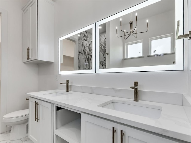 532 NW 112th St, Oklahoma City, OK 73114 - bathroom with marble finish flooring, double vanity, and a chandelier