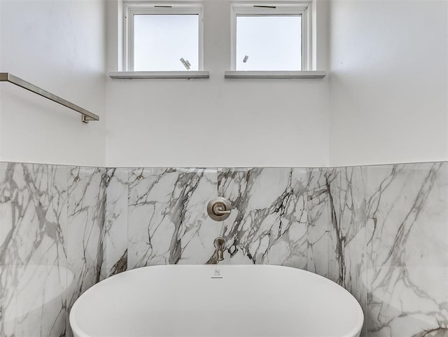 532 NW 112th St, Oklahoma City, OK 73114 - bathroom featuring tile walls, a soaking tub, and wainscoting