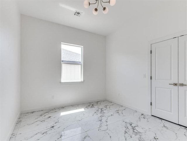 532 NW 112th St, Oklahoma City, OK 73114 - unfurnished room with light marble finish floors and a chandelier