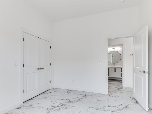 532 NW 112th St, Oklahoma City, OK 73114 - unfurnished bedroom featuring light marble finish flooring and a closet