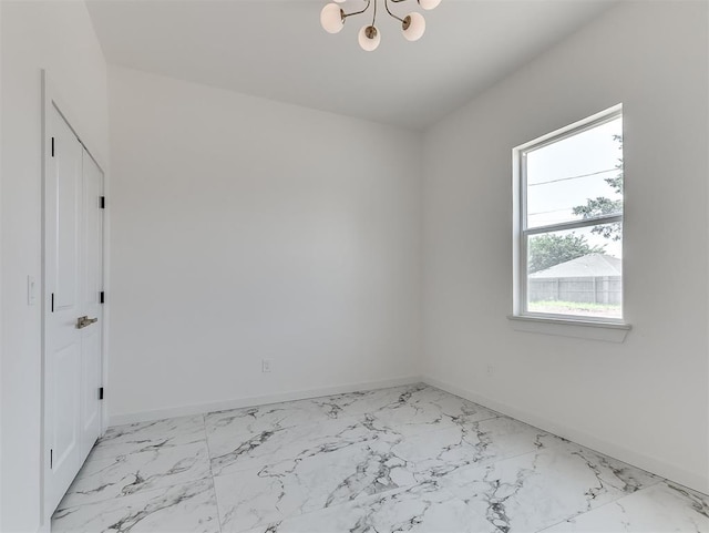532 NW 112th St, Oklahoma City, OK 73114 - unfurnished room with light marble finish floors and a chandelier