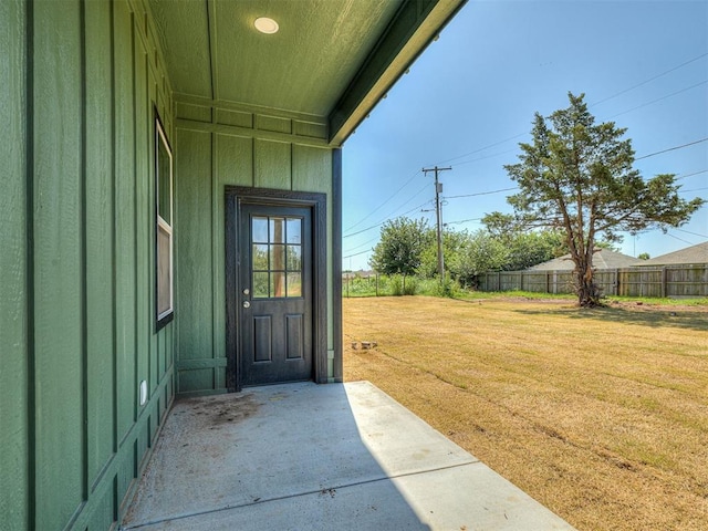 532 NW 112th St, Oklahoma City, OK 73114 - entrance to property with board and batten siding and a patio