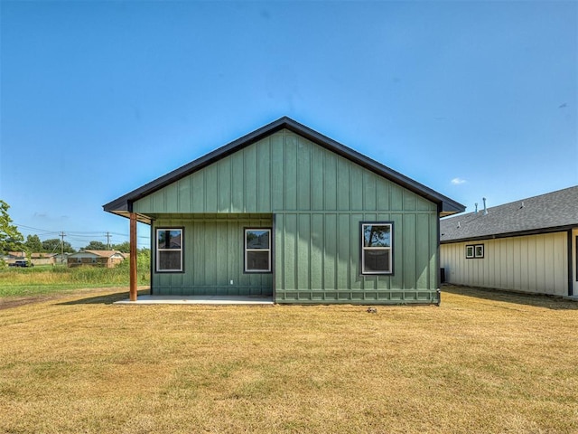 532 NW 112th St, Oklahoma City, OK 73114 - rear view of property featuring a yard, a patio area, and board and batten siding
