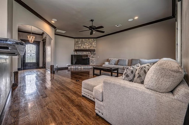 3205 Sycamore Dr, Moore, OK 73160 - living area with crown molding, ceiling fan, wood finished floors, a fireplace, and arched walkways