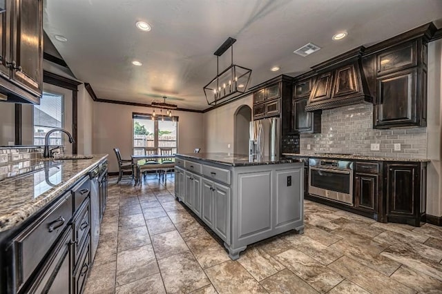 3205 Sycamore Dr, Moore, OK 73160 - kitchen with appliances with stainless steel finishes, backsplash, custom range hood, dark stone counters, and crown molding