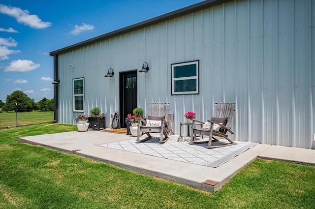 831 County St Unit 2917, Tuttle, OK 73089 - rear view of property featuring a patio, a lawn, and board and batten siding