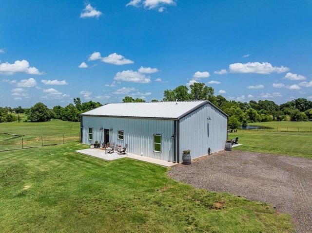 831 County St Unit 2917, Tuttle, OK 73089 - rear view of property with a pole building, an outdoor structure, a metal roof, and a patio area