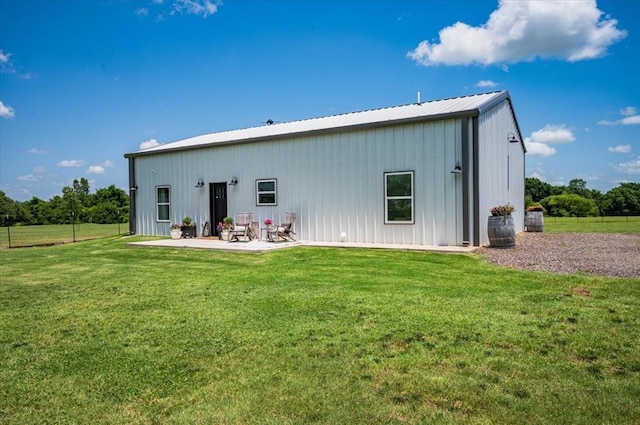 831 County St Unit 2917, Tuttle, OK 73089 - rear view of property featuring board and batten siding, a yard, a patio, and a metal roof