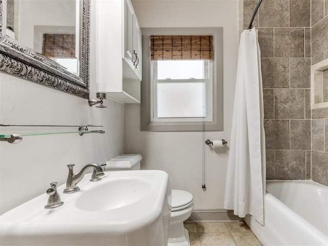 2420 NW 21st St, Oklahoma City, OK 73107 - bathroom featuring toilet and shower / bath combination with curtain
