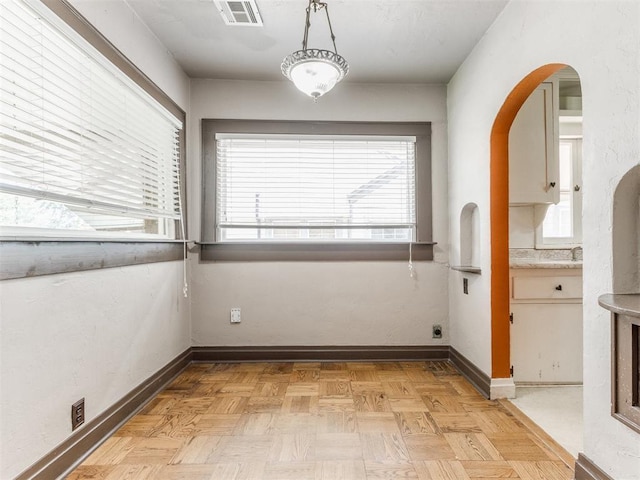 2420 NW 21st St, Oklahoma City, OK 73107 - unfurnished dining area with baseboards and arched walkways