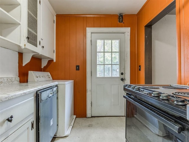 2420 NW 21st St, Oklahoma City, OK 73107 - laundry area with washer / dryer and wooden walls