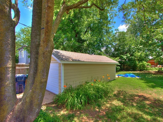 2420 NW 21st St, Oklahoma City, OK 73107 - view of property exterior featuring an outdoor structure, a detached garage, and roof with shingles