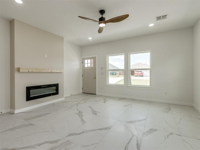 426 NW 115th St, Oklahoma City, OK 73114 - unfurnished living room with a glass covered fireplace, a ceiling fan, recessed lighting, and light marble finish flooring