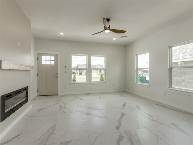 426 NW 115th St, Oklahoma City, OK 73114 - entryway with healthy amount of natural light, a ceiling fan, recessed lighting, light marble finish flooring, and a glass covered fireplace
