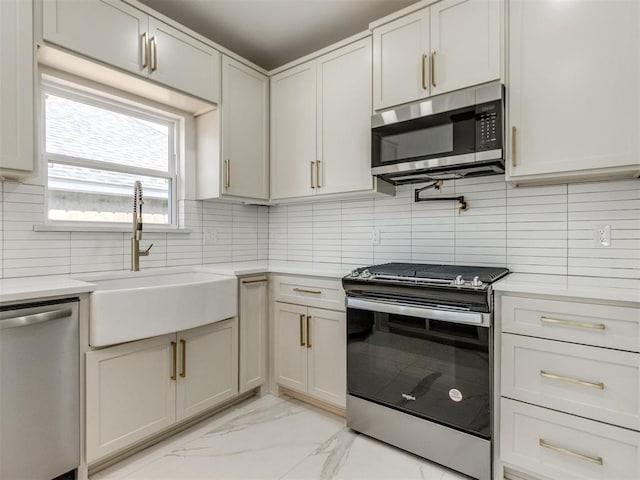 426 NW 115th St, Oklahoma City, OK 73114 - kitchen with stainless steel appliances, light marble finish floors, light countertops, and decorative backsplash