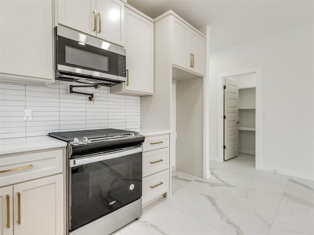 426 NW 115th St, Oklahoma City, OK 73114 - kitchen with stainless steel appliances, light marble finish floors, tasteful backsplash, and light countertops