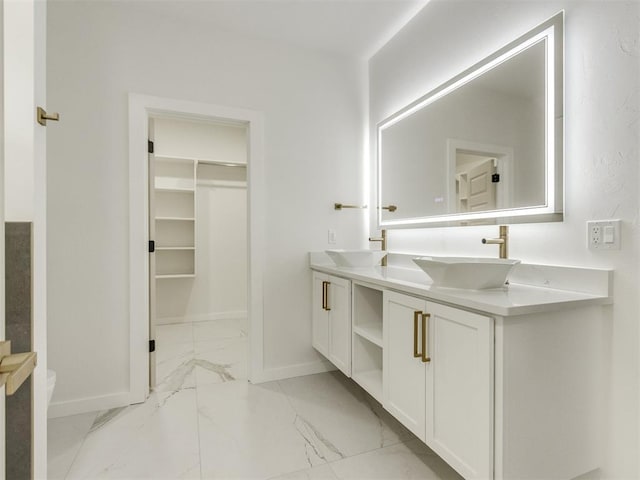 426 NW 115th St, Oklahoma City, OK 73114 - bathroom with marble finish flooring, double vanity, and a spacious closet