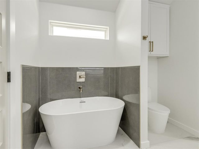 426 NW 115th St, Oklahoma City, OK 73114 - bathroom featuring marble finish flooring and a freestanding bath