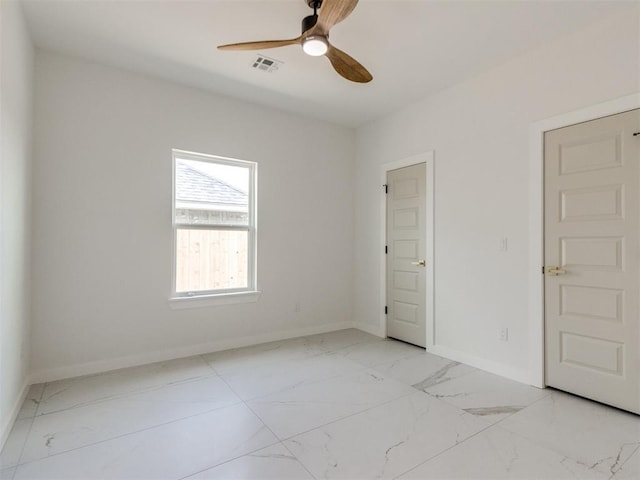 426 NW 115th St, Oklahoma City, OK 73114 - unfurnished room with marble finish floors and a ceiling fan