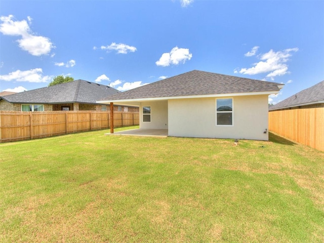 426 NW 115th St, Oklahoma City, OK 73114 - back of house featuring stucco siding, a fenced backyard, a patio area, and a shingled roof