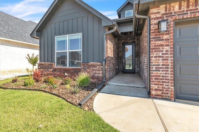 6605 NW 147th St, Oklahoma City, OK 73013 - doorway to property featuring board and batten siding, brick siding, and a yard