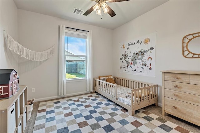 6605 NW 147th St, Oklahoma City, OK 73013 - carpeted bedroom with a ceiling fan and a crib