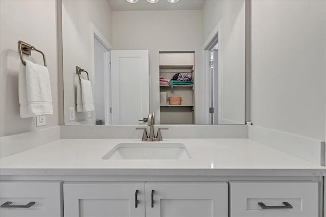 6605 NW 147th St, Oklahoma City, OK 73013 - bathroom featuring vanity and a walk in closet