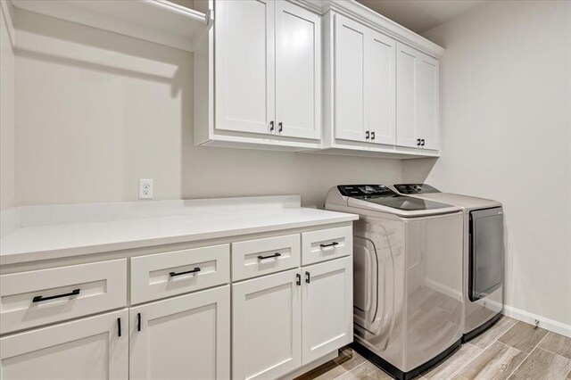 6605 NW 147th St, Oklahoma City, OK 73013 - washroom featuring cabinet space, washing machine and dryer, and wood finish floors