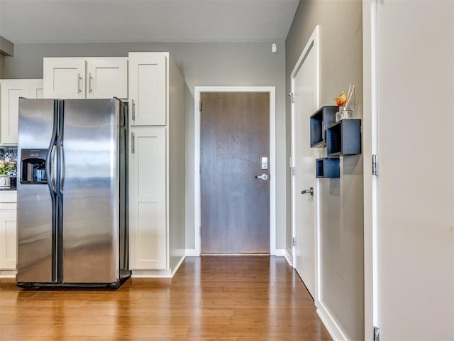 1 NE 2nd St Unit 309, Oklahoma City, OK 73104 - kitchen featuring stainless steel fridge with ice dispenser, light wood-style floors, and white cabinets