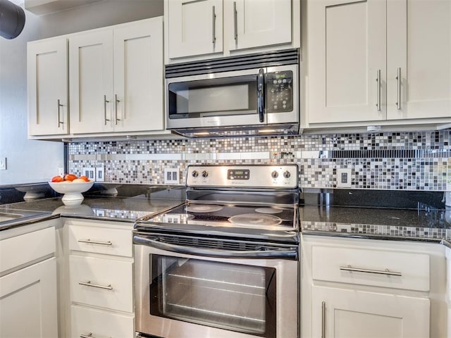 1 NE 2nd St Unit 309, Oklahoma City, OK 73104 - kitchen with appliances with stainless steel finishes, backsplash, white cabinets, and dark stone counters