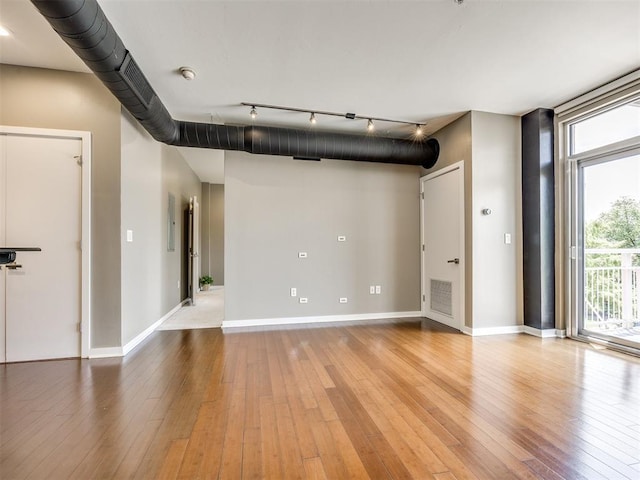 1 NE 2nd St Unit 309, Oklahoma City, OK 73104 - empty room featuring hardwood / wood-style floors, track lighting, and a smoke detector