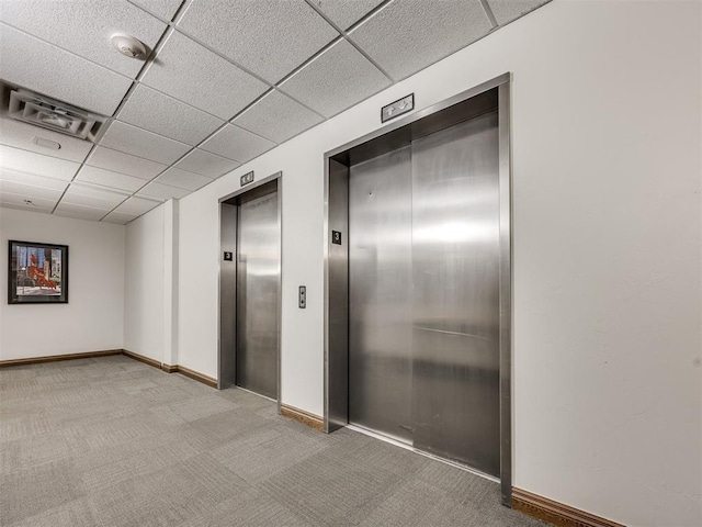1 NE 2nd St Unit 309, Oklahoma City, OK 73104 - corridor with elevator, a drop ceiling, and light carpet