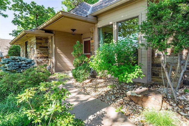 1600 Turtlecreek Rd, Edmond, OK 73013 - doorway to property featuring a shingled roof and stone siding