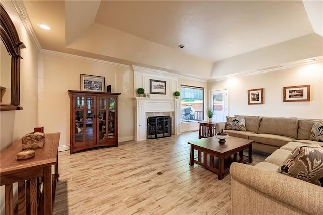 1600 Turtlecreek Rd, Edmond, OK 73013 - living area featuring a raised ceiling, light wood-type flooring, a fireplace, and crown molding