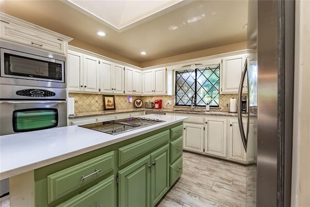 1600 Turtlecreek Rd, Edmond, OK 73013 - kitchen with stainless steel appliances, green cabinetry, white cabinetry, light countertops, and recessed lighting