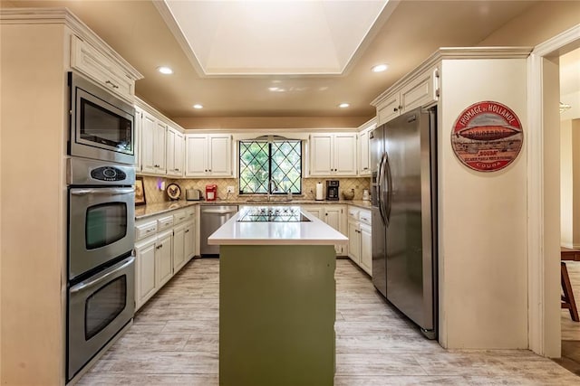 1600 Turtlecreek Rd, Edmond, OK 73013 - kitchen with stainless steel appliances, a kitchen island, light wood-style flooring, backsplash, and recessed lighting