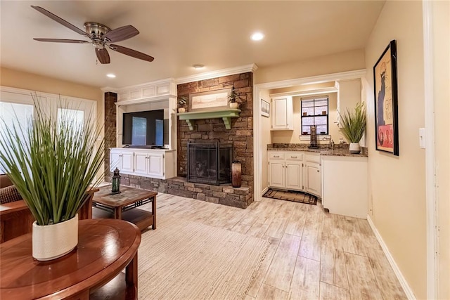 1600 Turtlecreek Rd, Edmond, OK 73013 - living area featuring light wood-style flooring, a fireplace, a ceiling fan, and recessed lighting