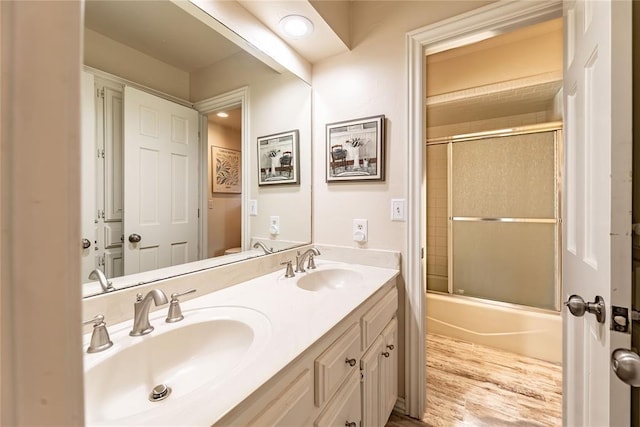 1600 Turtlecreek Rd, Edmond, OK 73013 - bathroom with double vanity, wood finished floors, and combined bath / shower with glass door